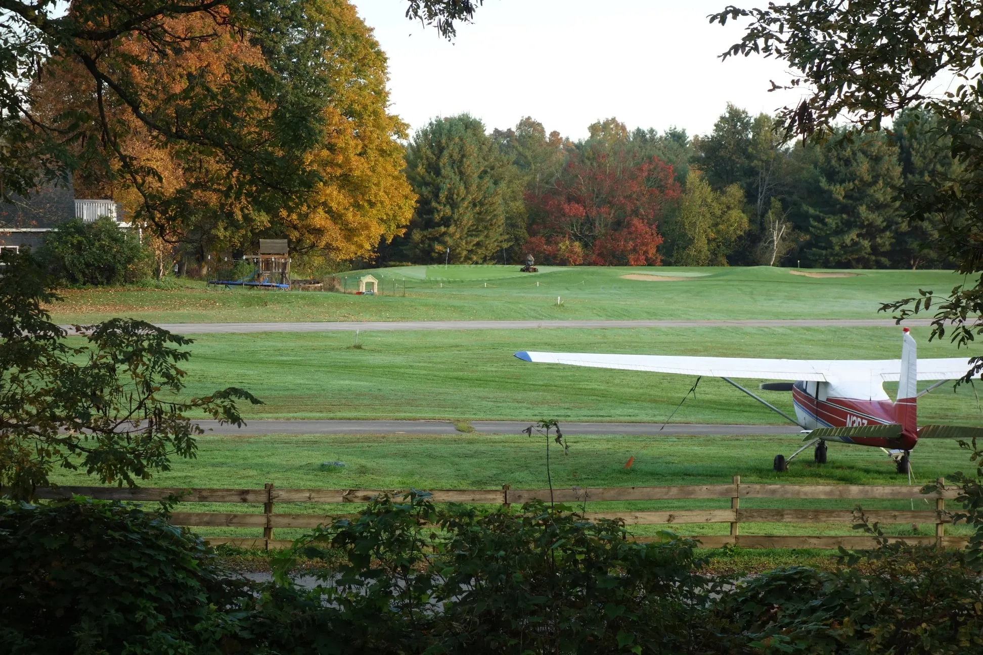 Plane parked beside the runway in fall